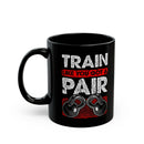 Black mug with 'Train Like You Got a Pair' text and kettlebell graphic on a white background